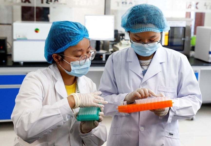 Employees at Beijing Applied Biological Technologies Co's R&D laboratory following the coronavirus outbreak. REUTERS.