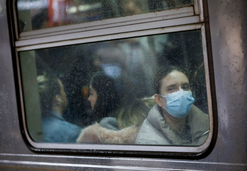 A passenger wears a protective face mask on a subway in Manhattan. REUTERS.