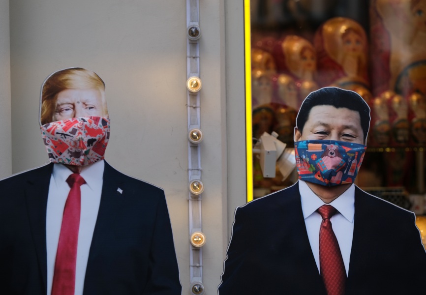 Cardboard cutouts of US President Donald Trump and Chinese President Xi Jinping wearing face masks. REUTERS.