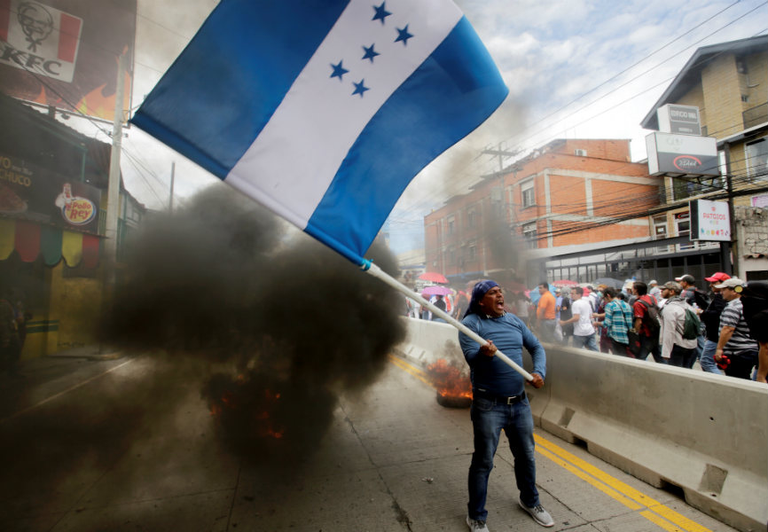 A demonstrator in Honduras protests against the government’s plans to privatize healthcare and education. REUTERS.