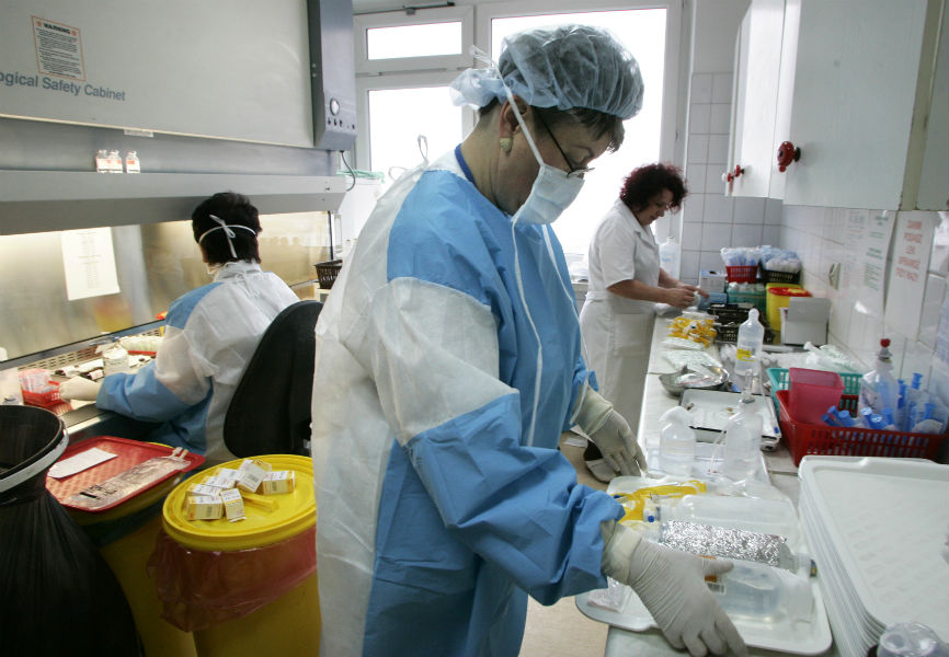 Healthcare workers prepare medicine at the Cancer Center and Institute of Oncology in Warsaw.