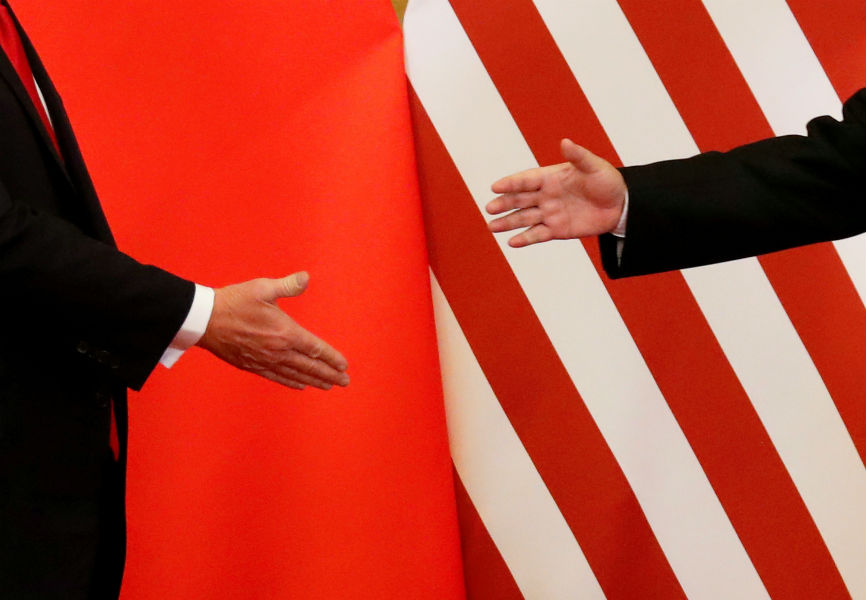 US President Donald Trump and Chinese President Xi Jinping shake hands. REUTERS.